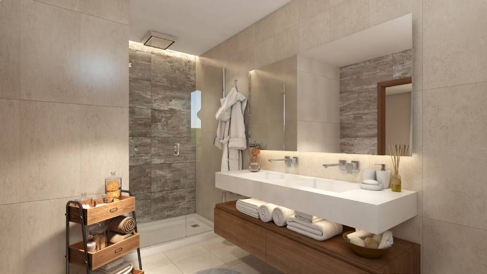 Salle de bains moderne avec murs carrelés en pierre, douche en verre, meuble-lavabo suspendu et rangements en bois.