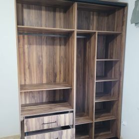 Un armario de madera con cajones y estantes en una habitación.