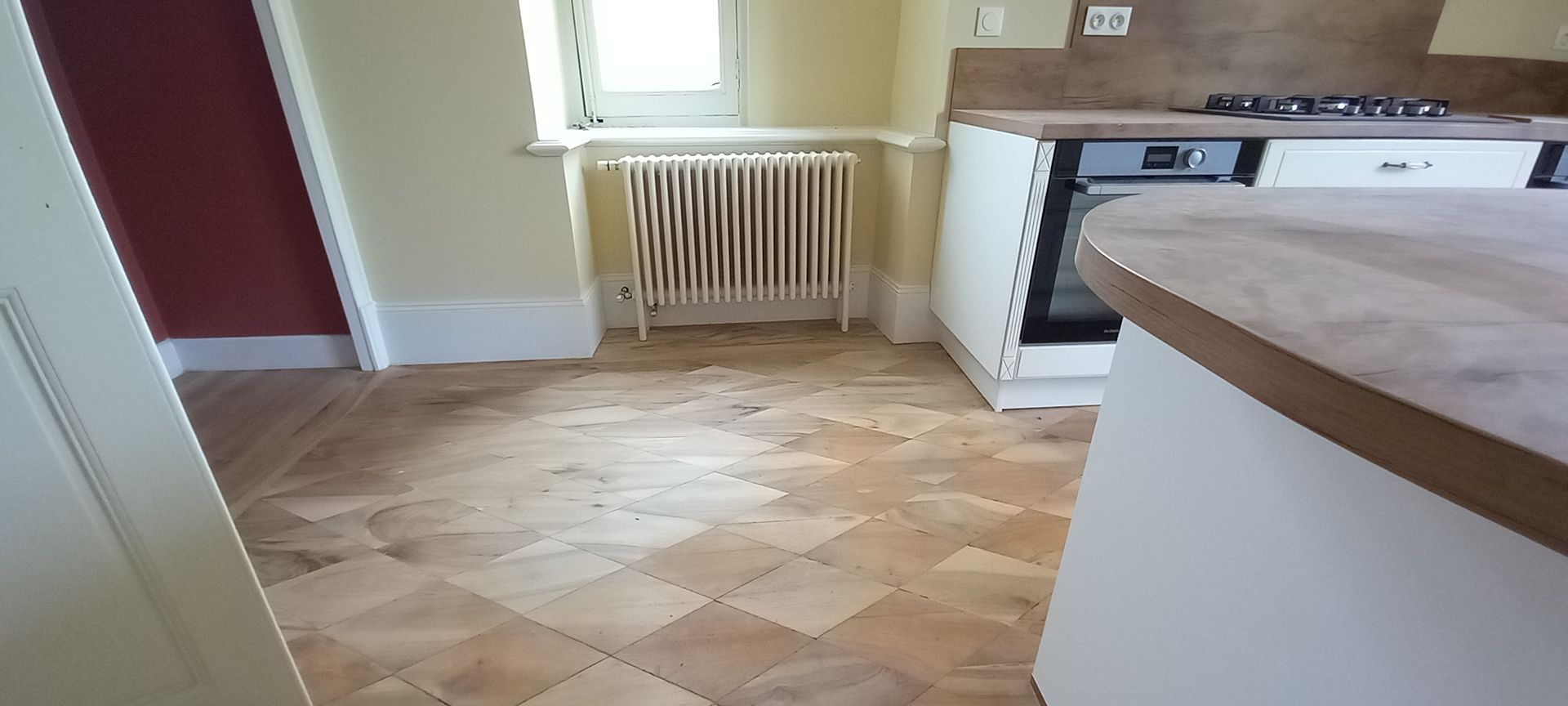 Un radiateur sur un parquet avec des carrés.