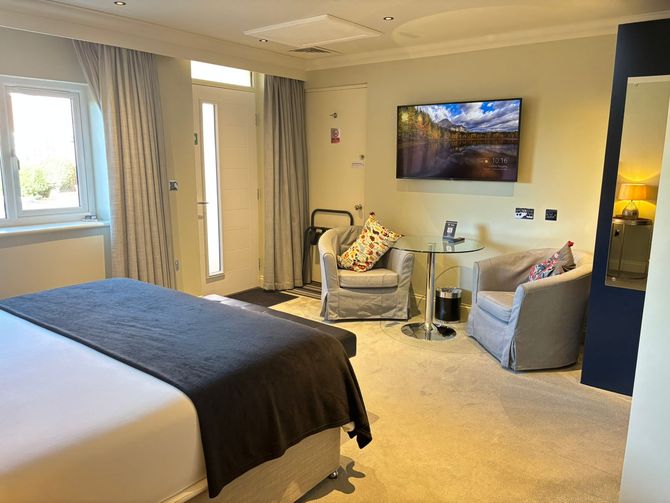 Image showing the internal room layout at Hillside Farm Apartments with its seating area and flat screen TV on the wall