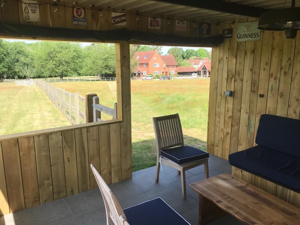 Image showing the view from a peaceful outside seating area  at Hillside Farm Apartments with the Farmhouse in the background