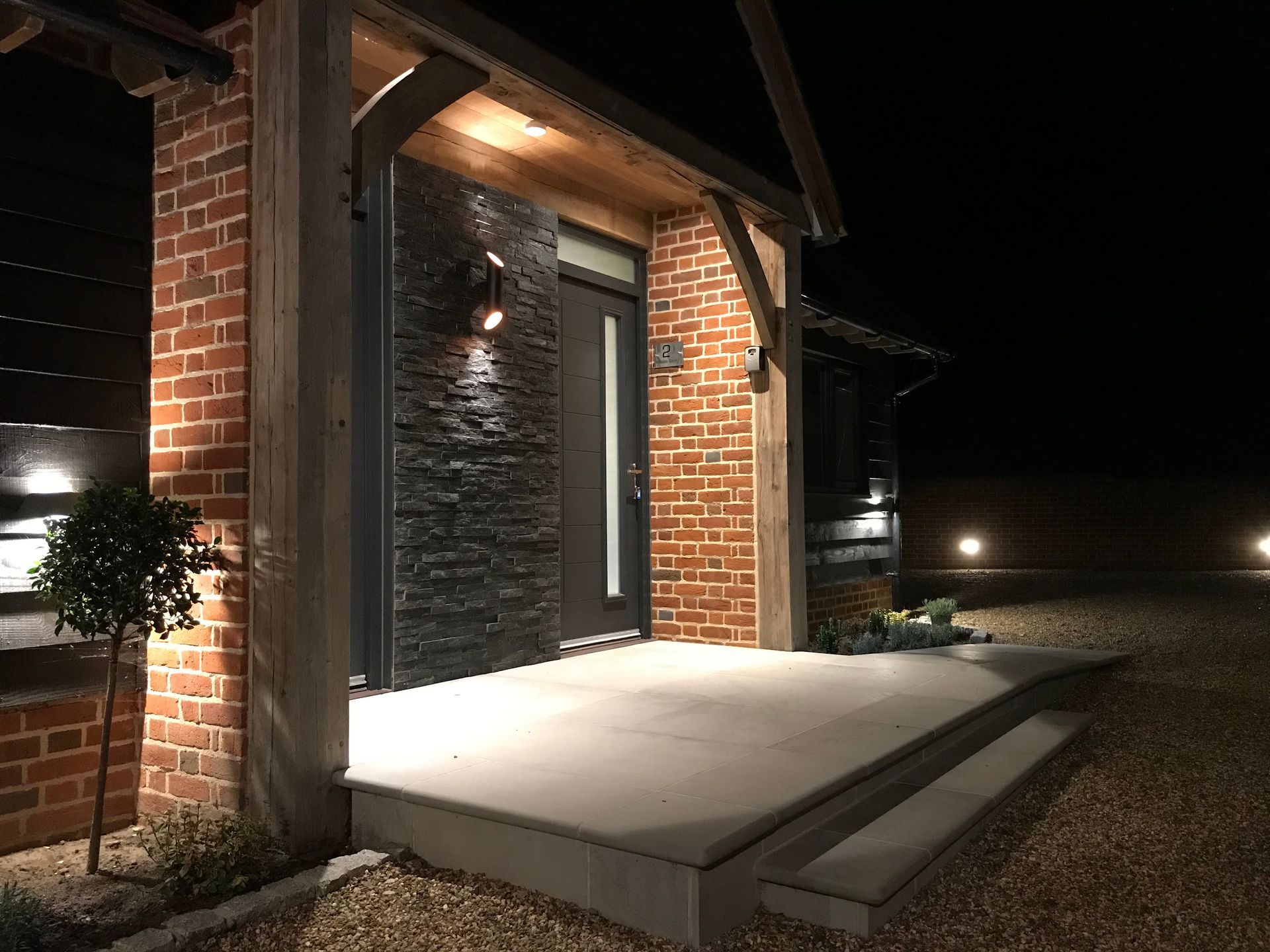 Image shows front entrance at Hillside Farm Apartments lit up at night