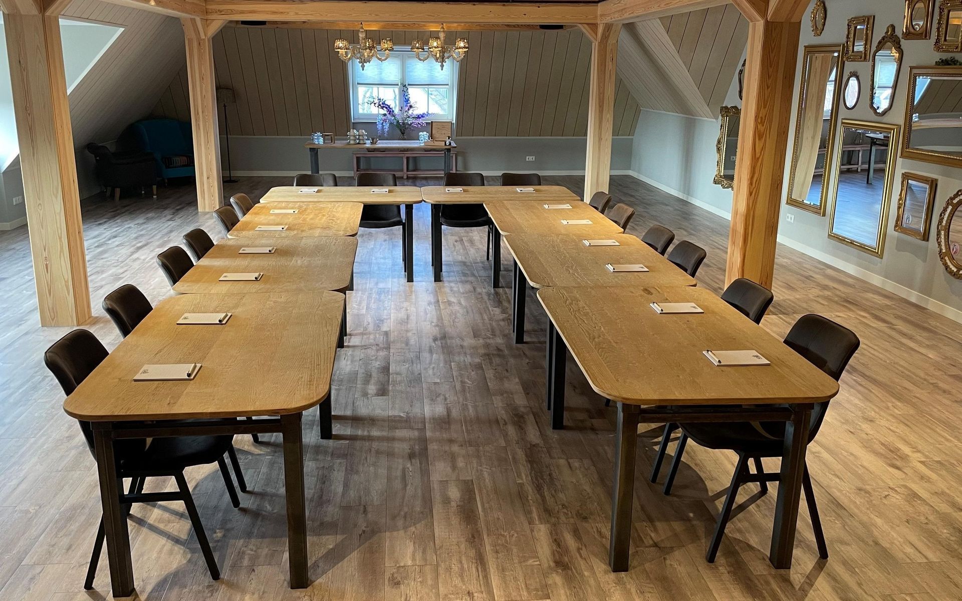 There are many tables and chairs in the room.