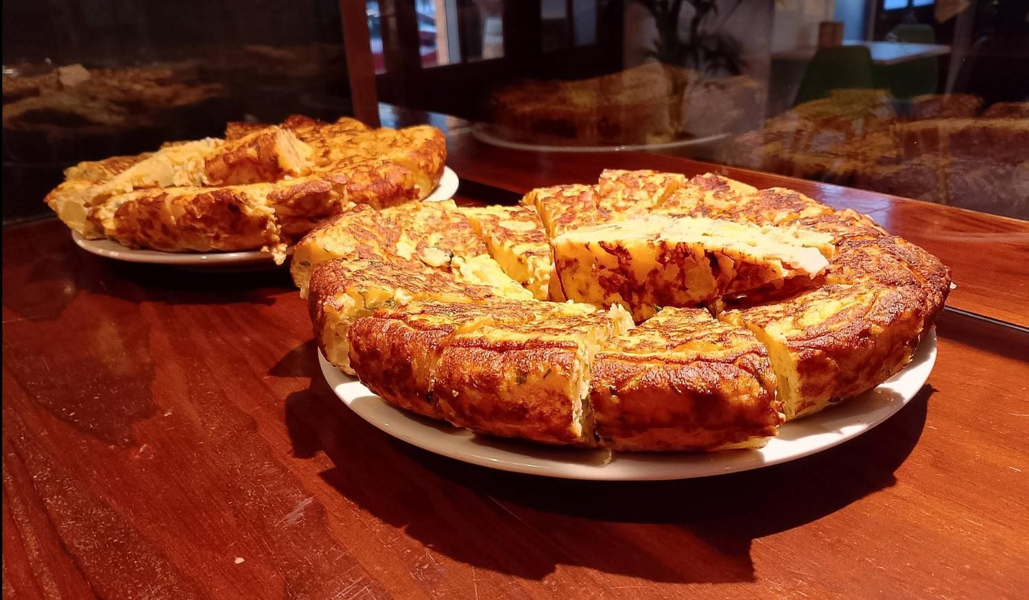 Dos platos de comida están sobre una mesa de madera.