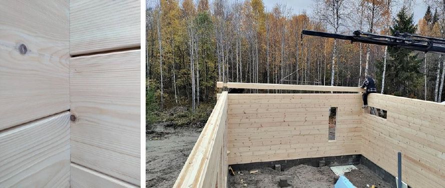 En trebygning under bygging med skog i bakgrunnen; en person sitter på en bjelke.