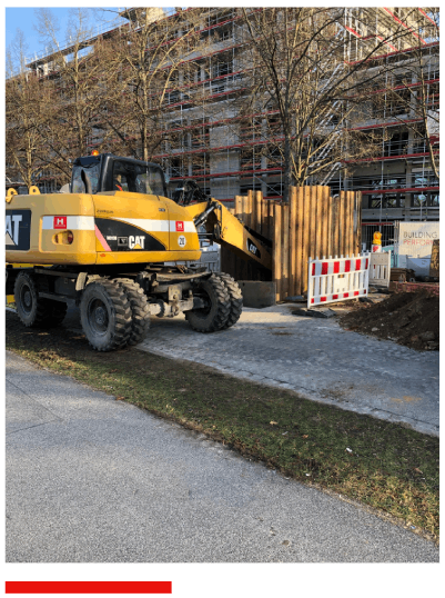 Ein gelber Cat-Bagger steht am Straßenrand