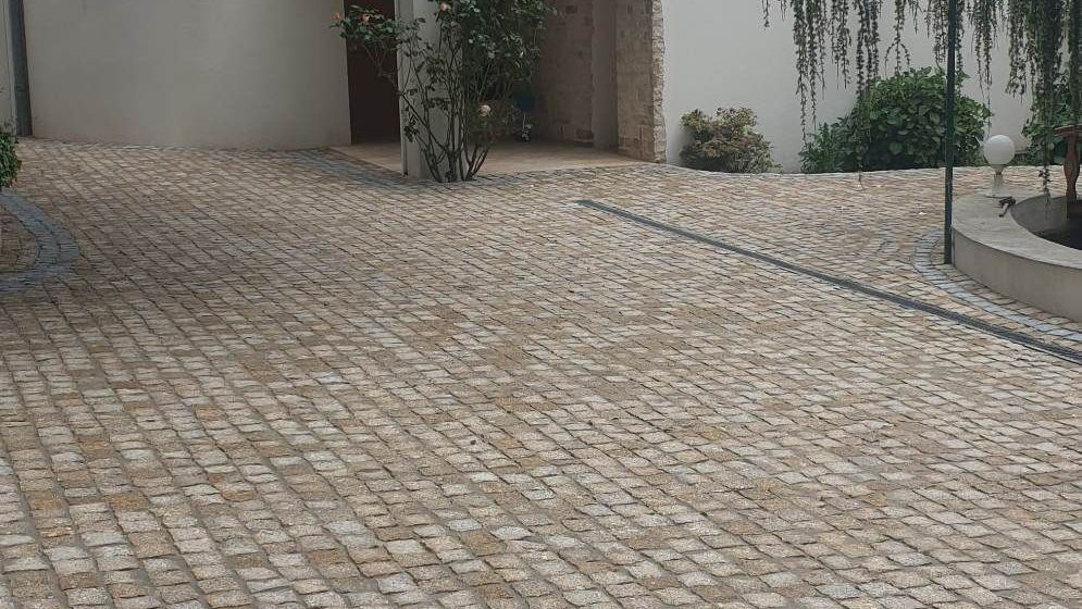 Cour d'une maison recouverte de pavés en granit