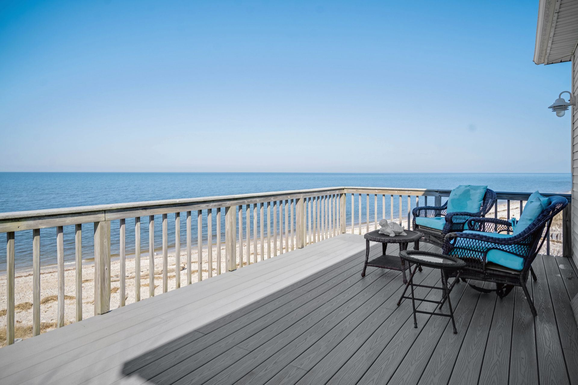 There is a large wooden deck with a table and chairs on it.