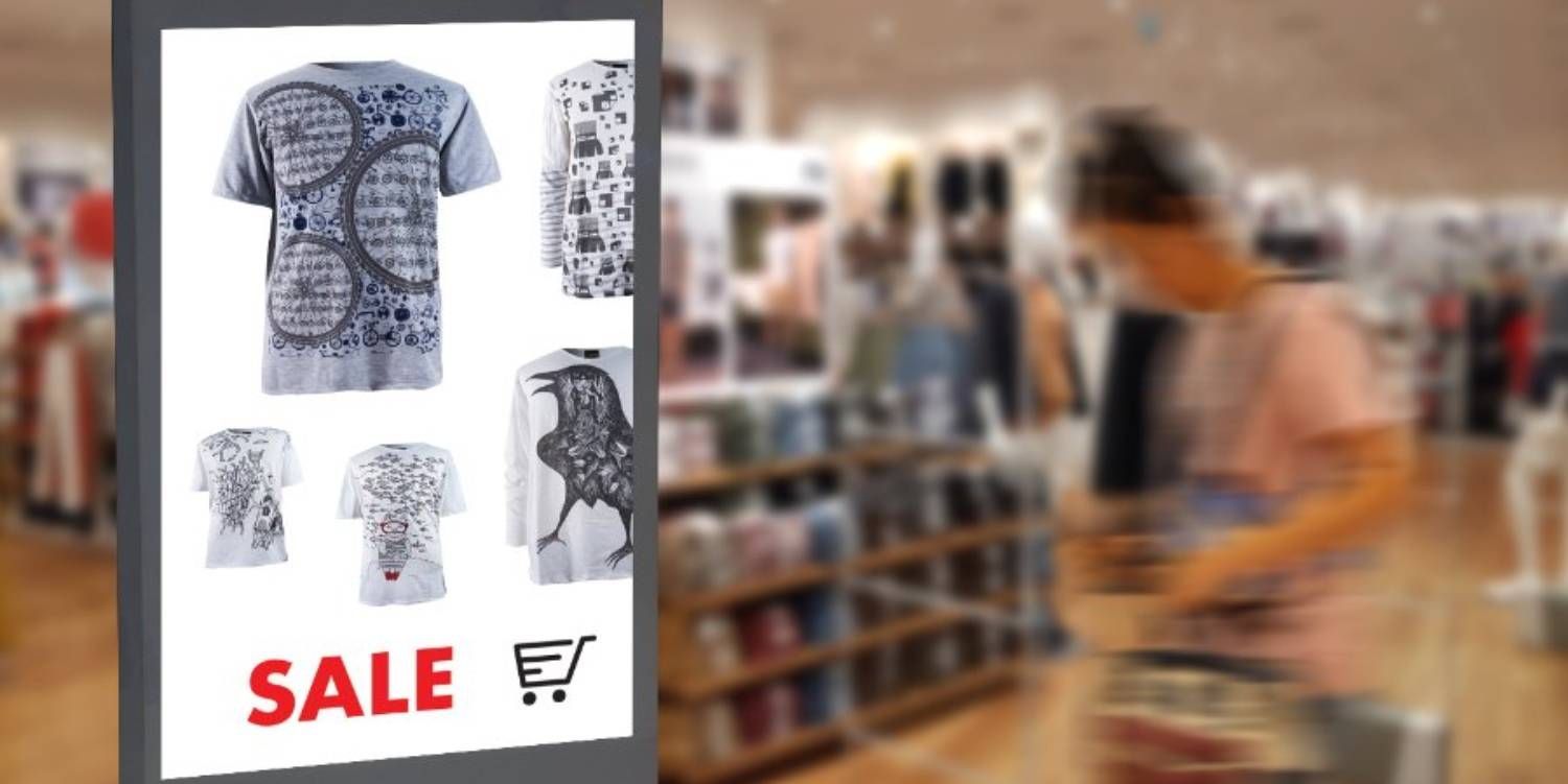 Un hombre está comprando en una tienda de ropa y mirando un cartel de oferta.