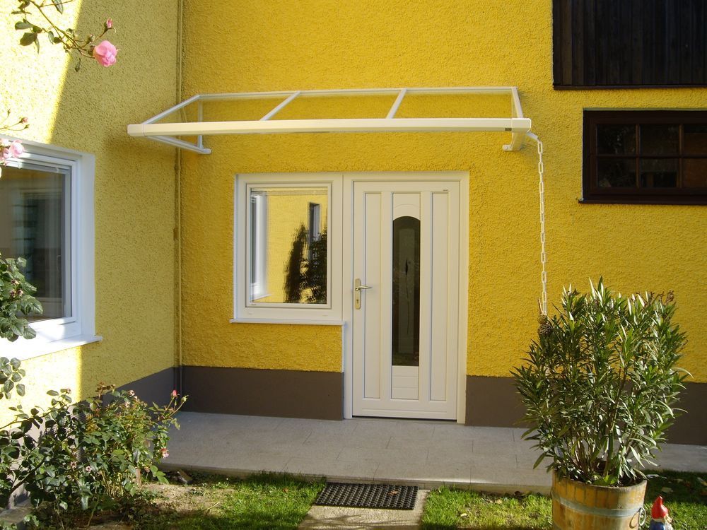 Ein gelbes Haus mit einer weißen Tür und einem weißen Fenster