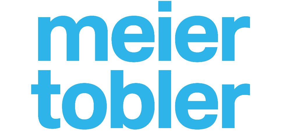 Das Logo von Meier Tobler ist blau und weiß auf weißem Hintergrund.
