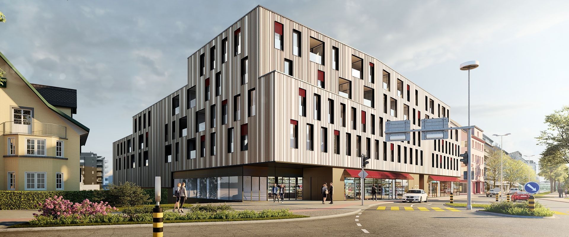 An einer Straßenecke steht ein großes Gebäude mit vielen Fenstern.