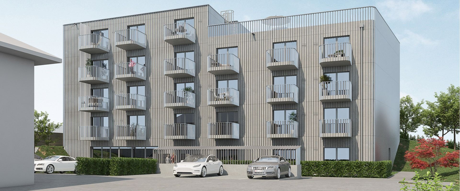 Ein großes Wohnhaus mit davor geparkten Autos.