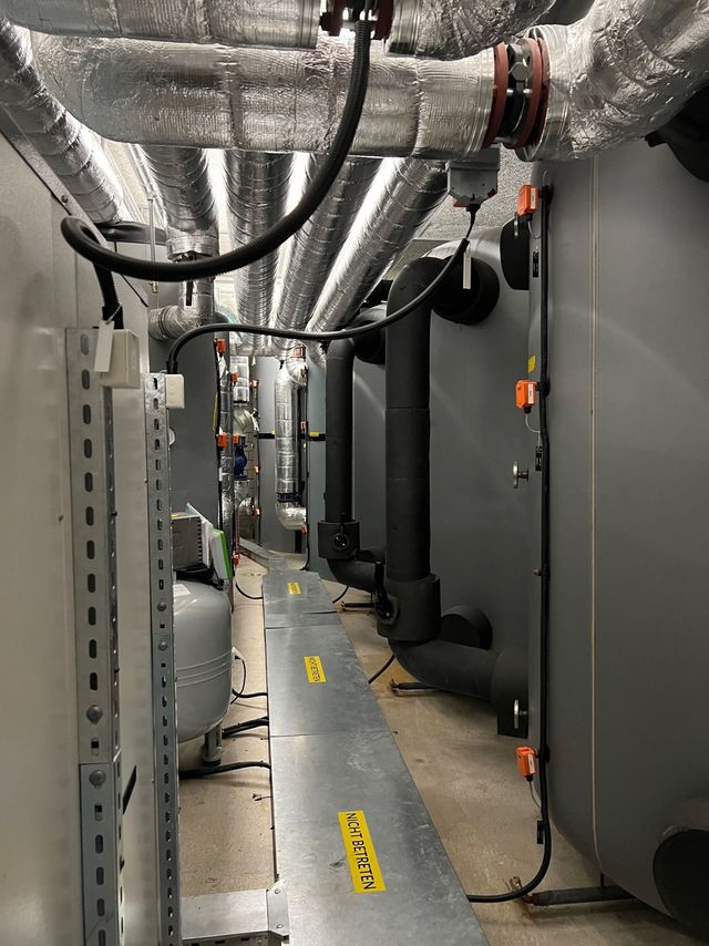 Ein langer Flur mit einem gelben Warnschild auf dem Boden