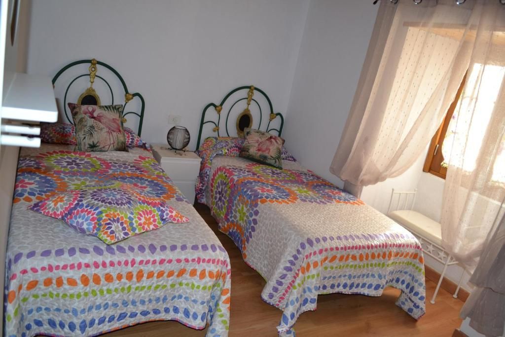 Un dormitorio con dos camas individuales y una ventana.