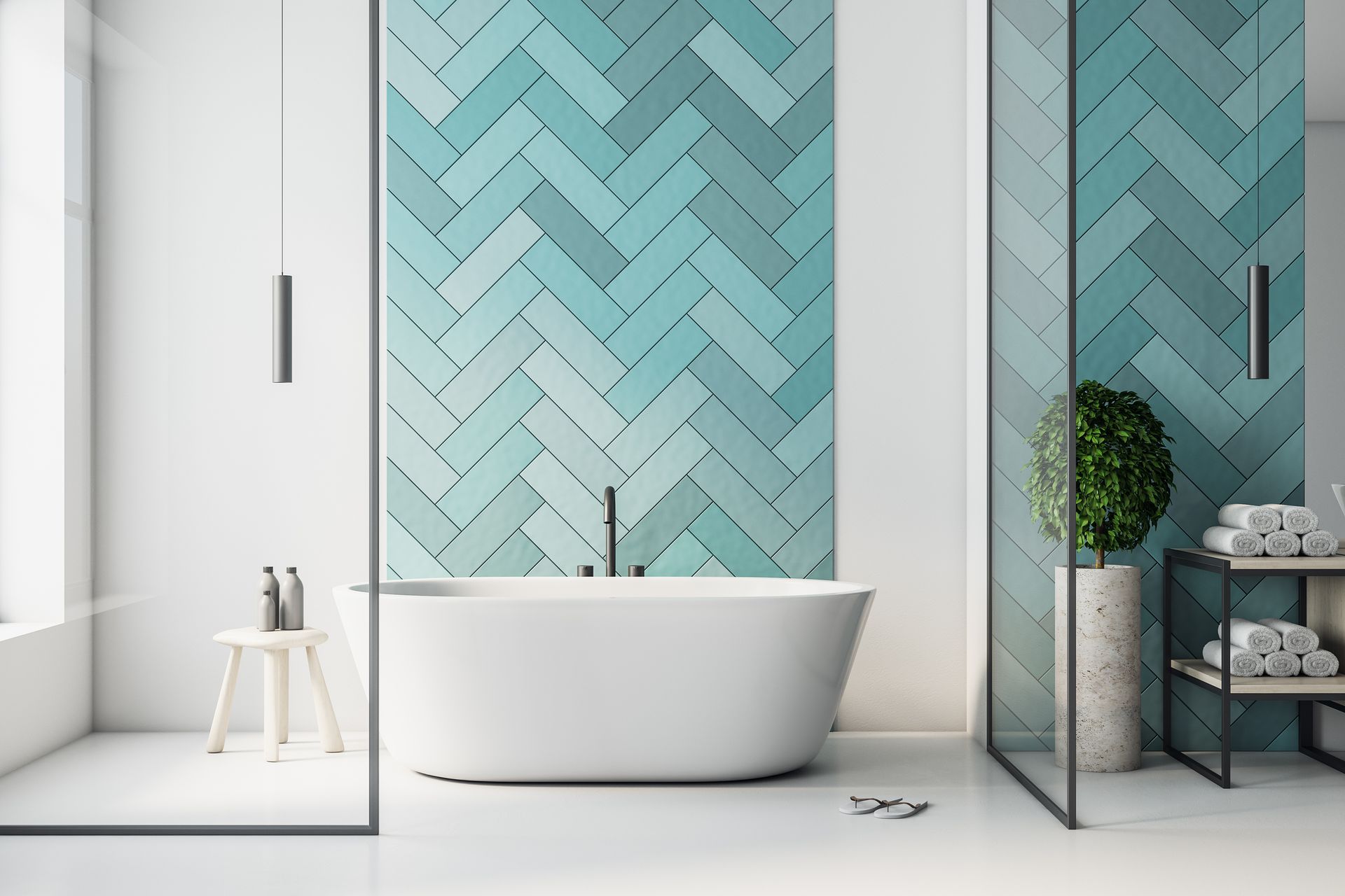 Salle de bains moderne avec mur d'accent à chevrons turquoise, baignoire blanche et douche en verre.