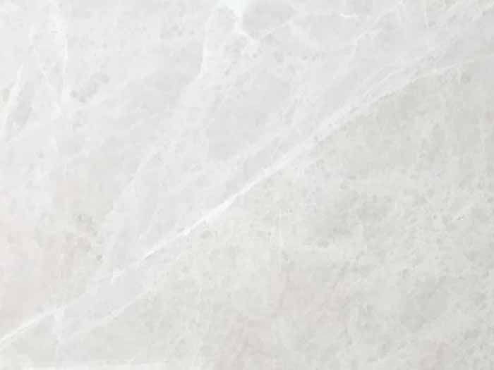 Un primer plano de un azulejo blanco con textura de mármol.