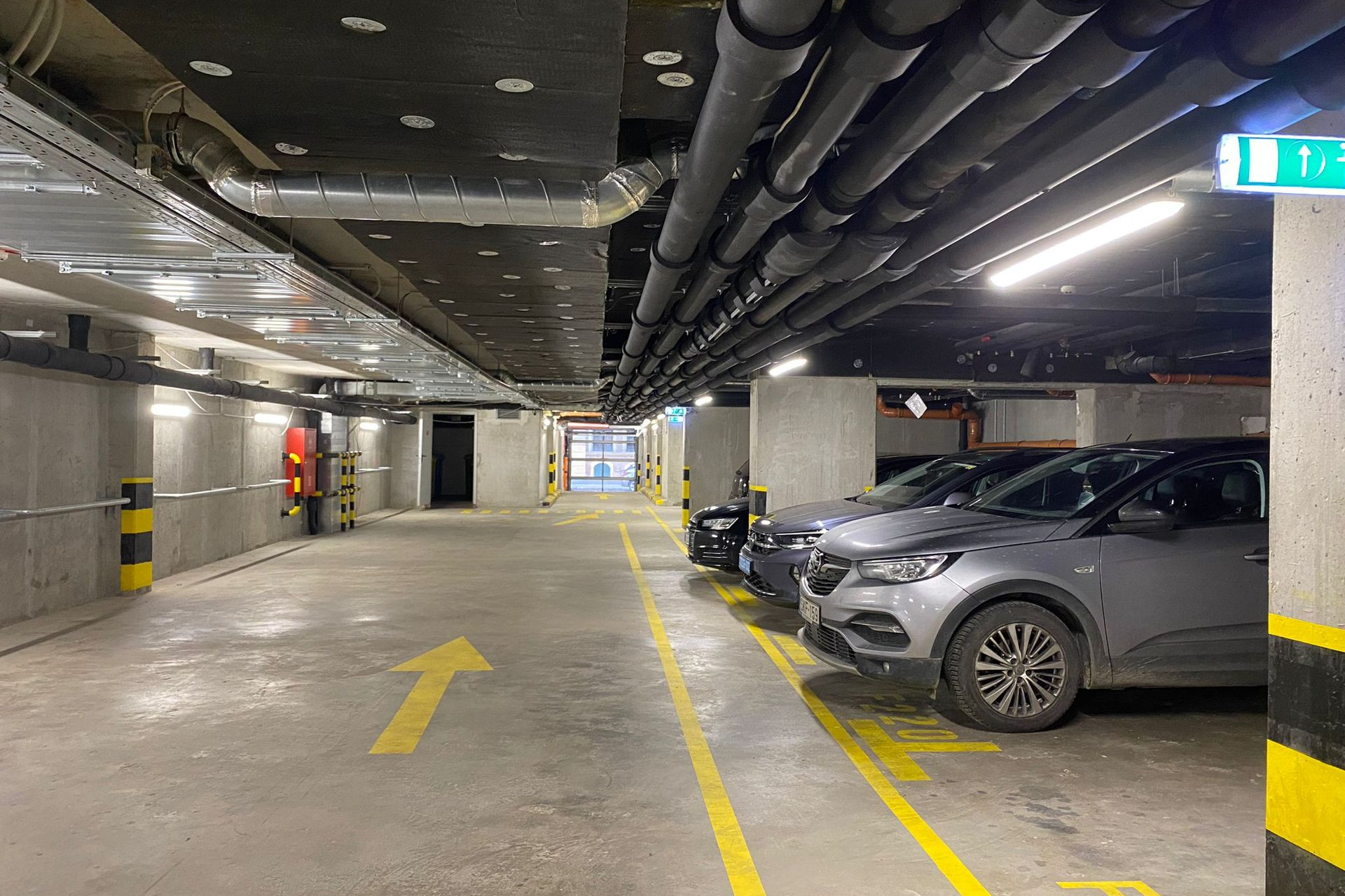 Marone Parking at Marone Residence Apartments, Budapest, Hungary. Underground parking garage with parked cars.