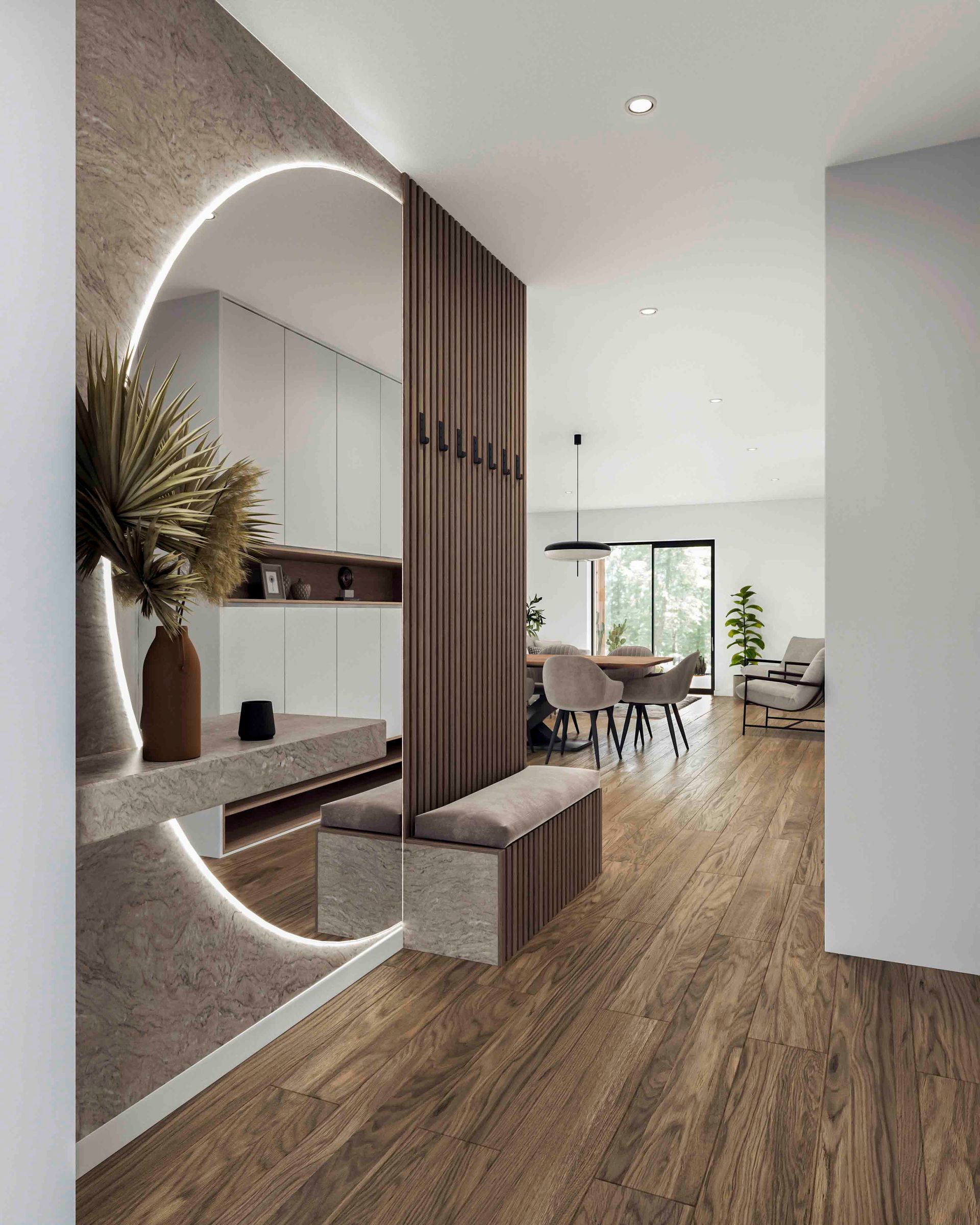 Ein moderner Eingangsbereich mit einem großen runden Spiegel mit Hintergrundbeleuchtung, einer Trennwand aus Holzlamellen