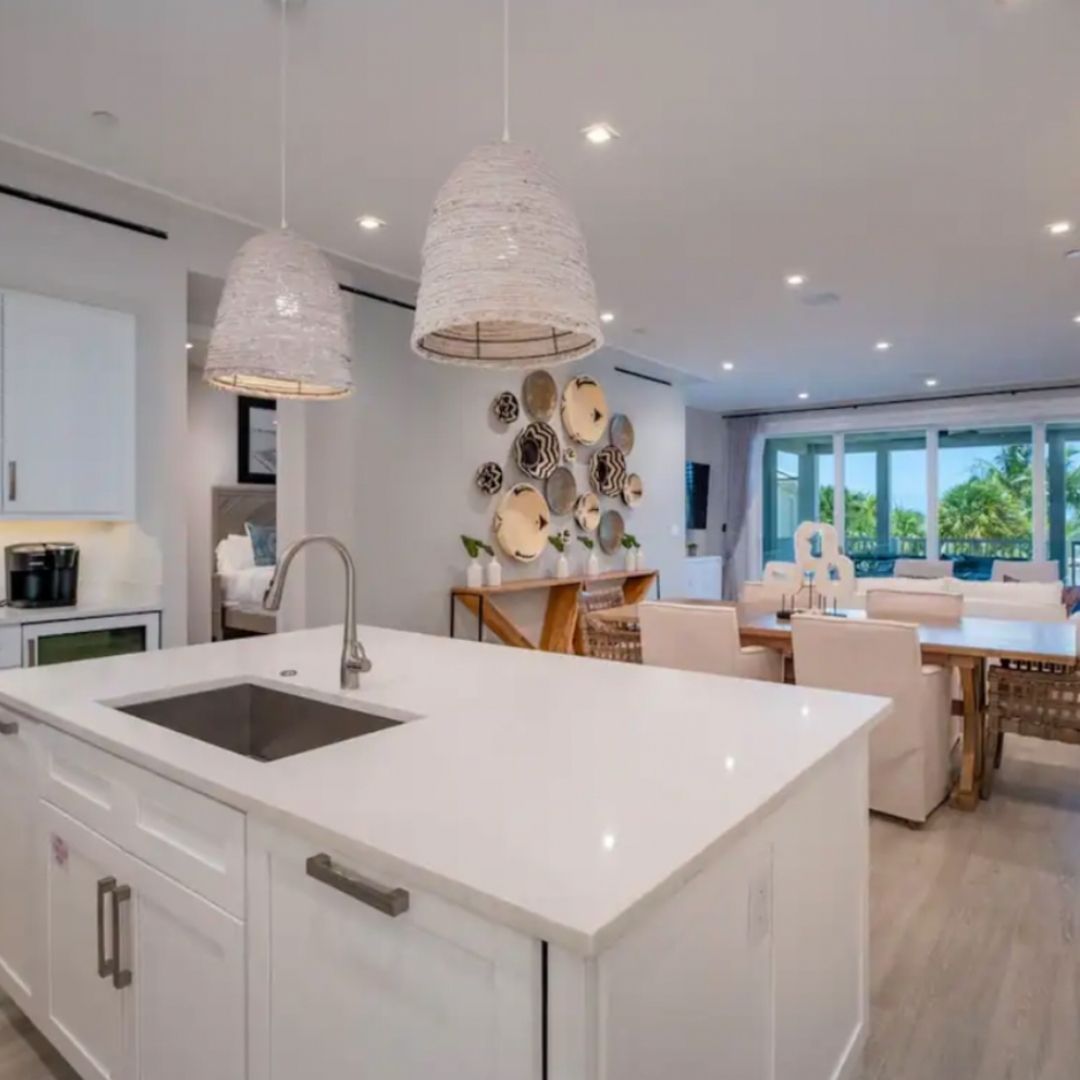 Modern gourmet kitchen with white island and pendant lighting at Maison 203.