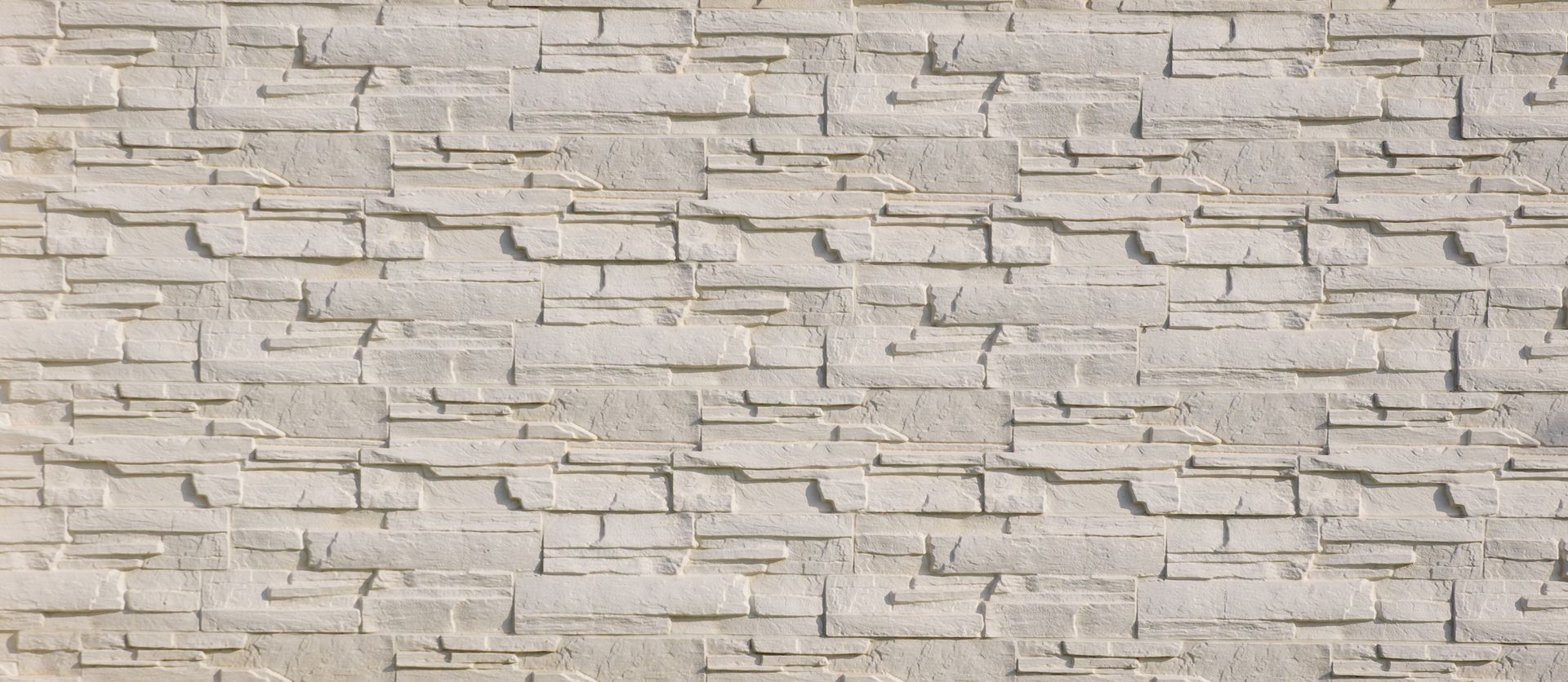 Texture de mur en briques gris clair.