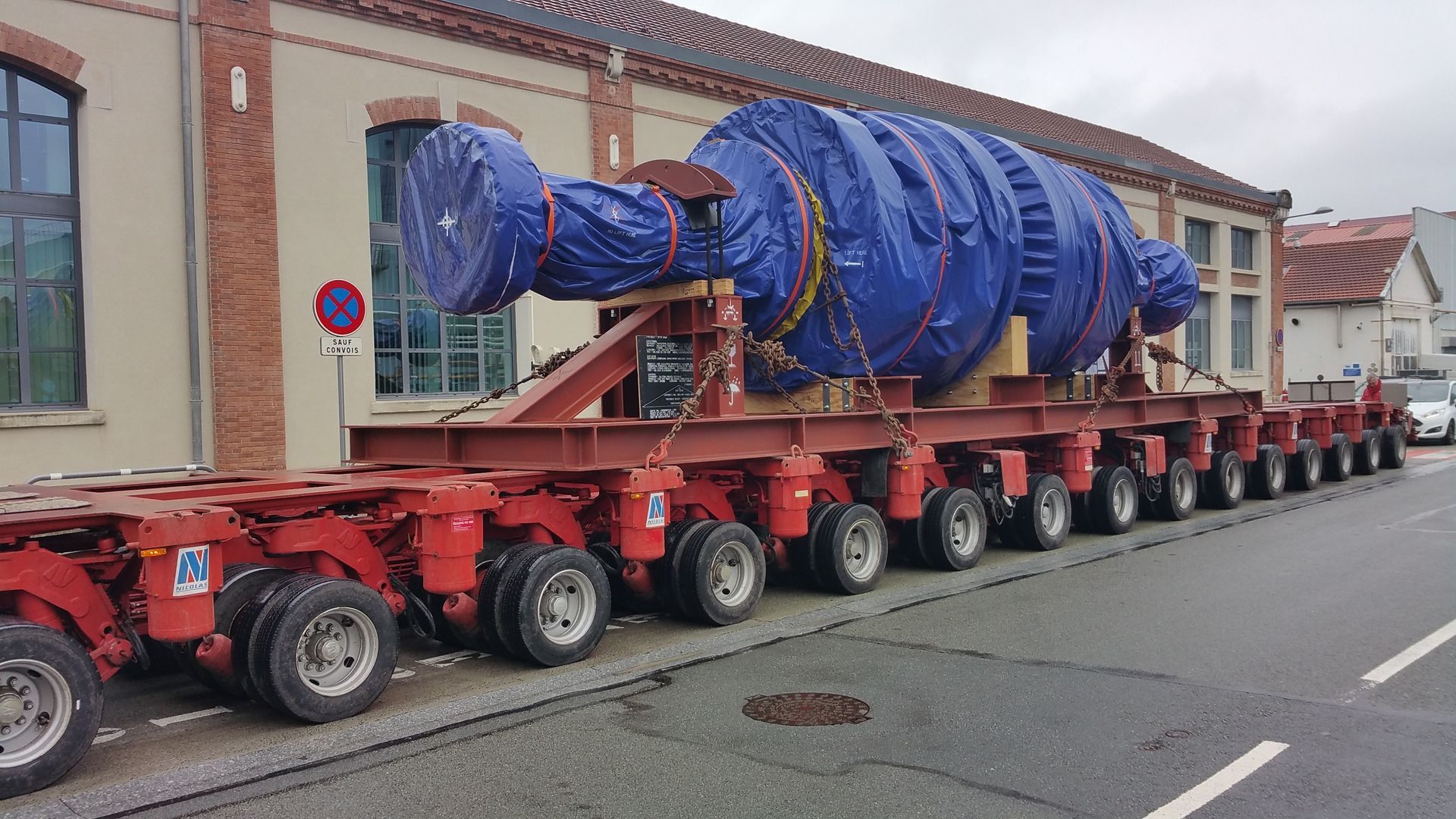 Remorque multi roues transportant une grande pièce d'aéronautique