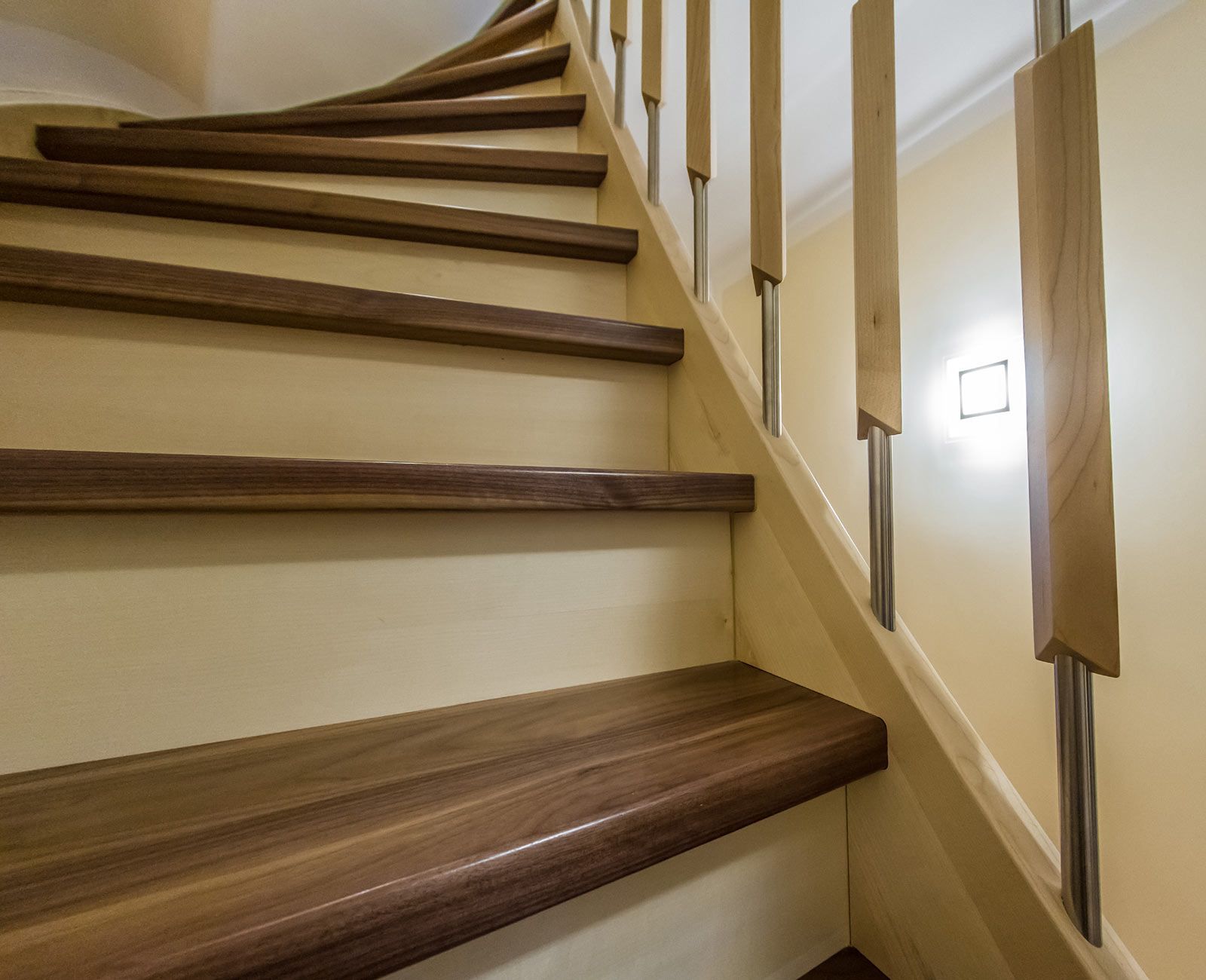 Eine Nahaufnahme einer Holztreppe mit einem Metallgeländer