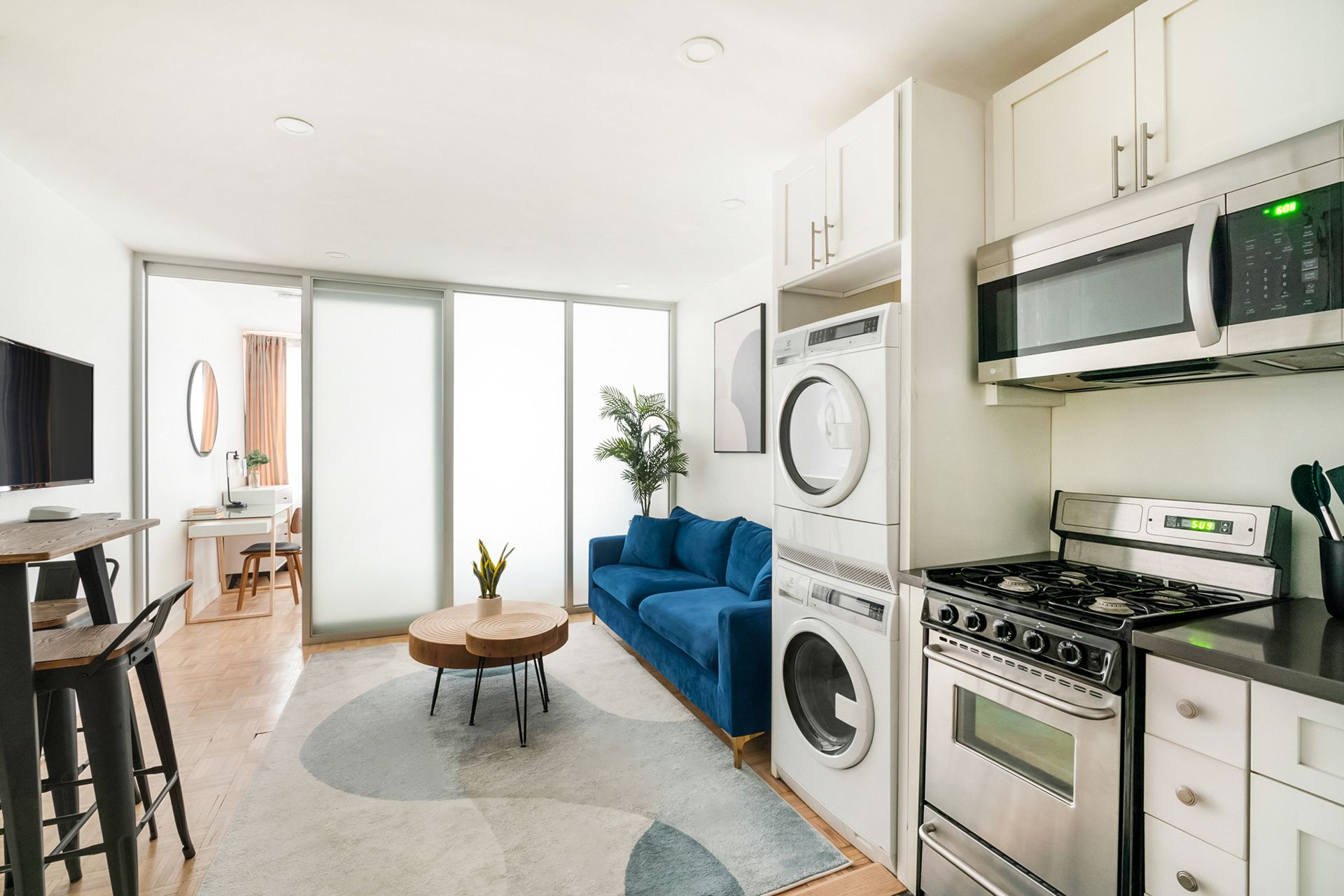 Living room with frosted sliding doors, gray sofa, and modern decor.
