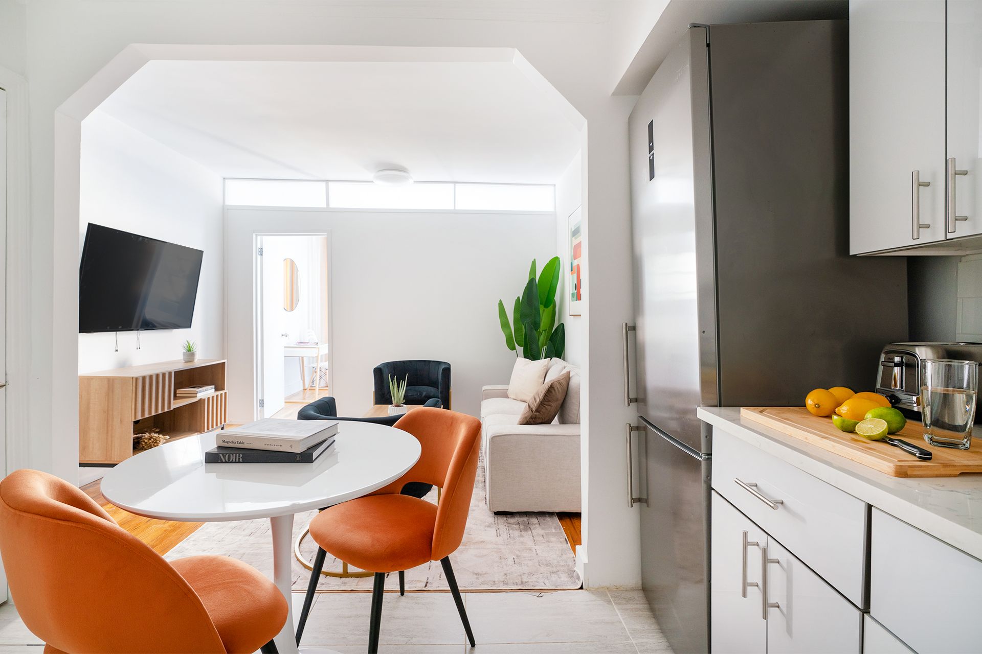 One-bedroom apartment with a dining area, modern decor, and large windows. Located in Midtown West, includes elevator access.