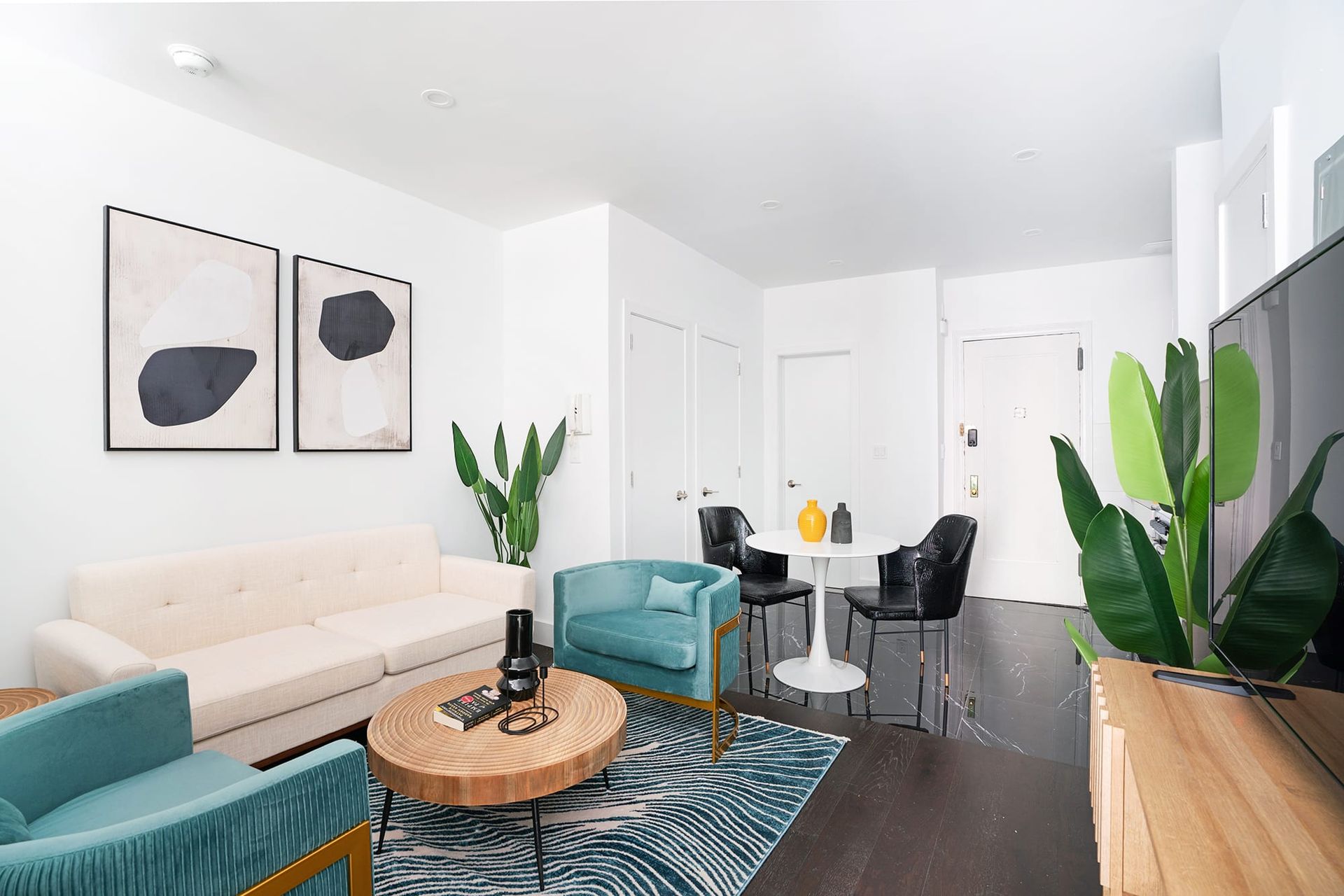 One-bedroom apartment with comfortable living area, modern furniture, dining table, and plants. Located in Midtown West.