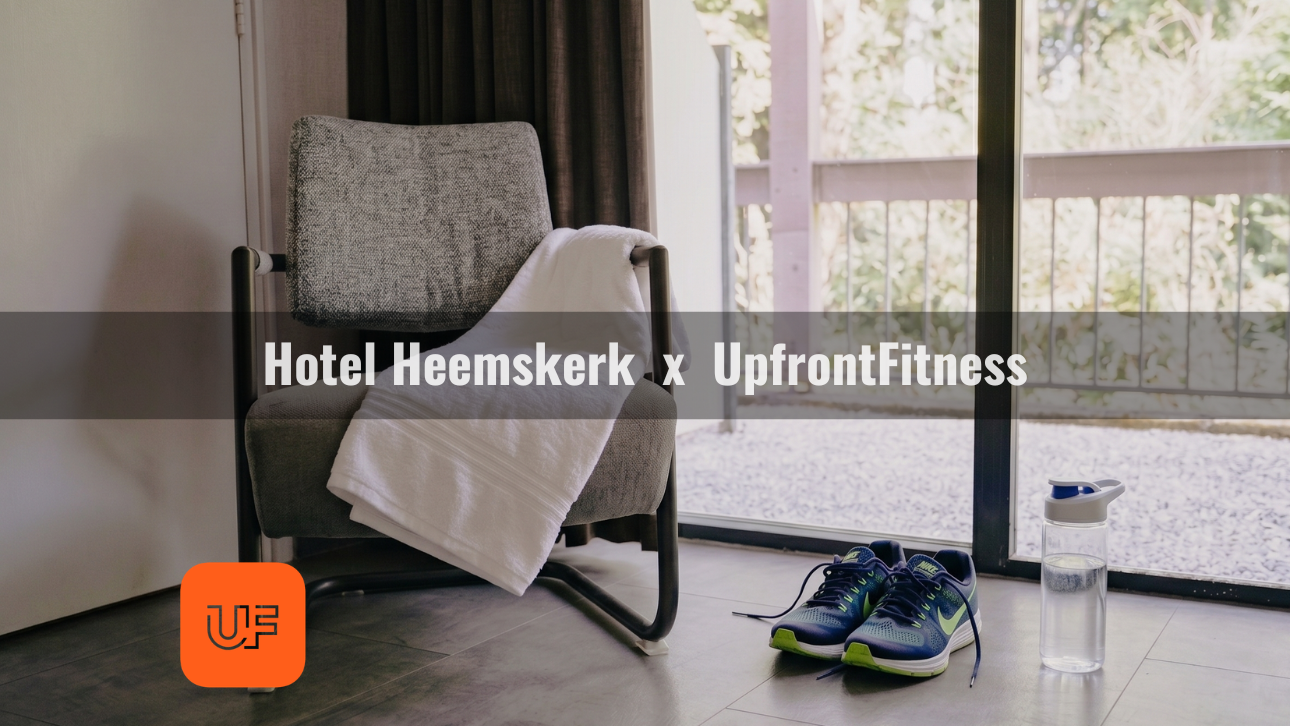 A hotel room at Hotel Heemskerk featuring running shoes, a water bottle, and a towel on a chair, ready for an UpFrontFitness workout.