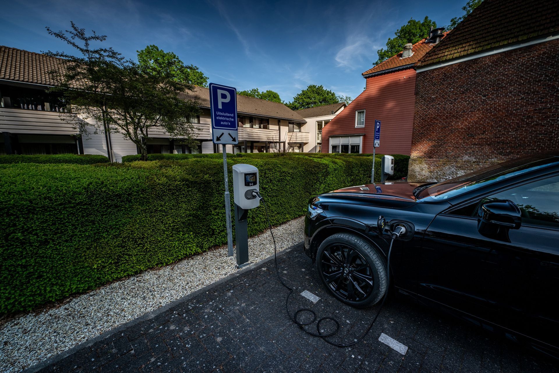 Charging station for electric cars with designated parking space next to the hotel.