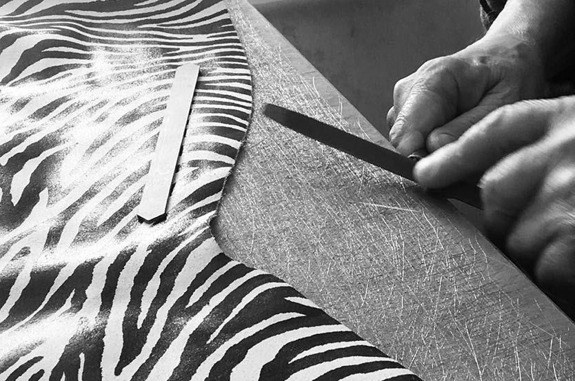 A black and white photo of a person filing their nails