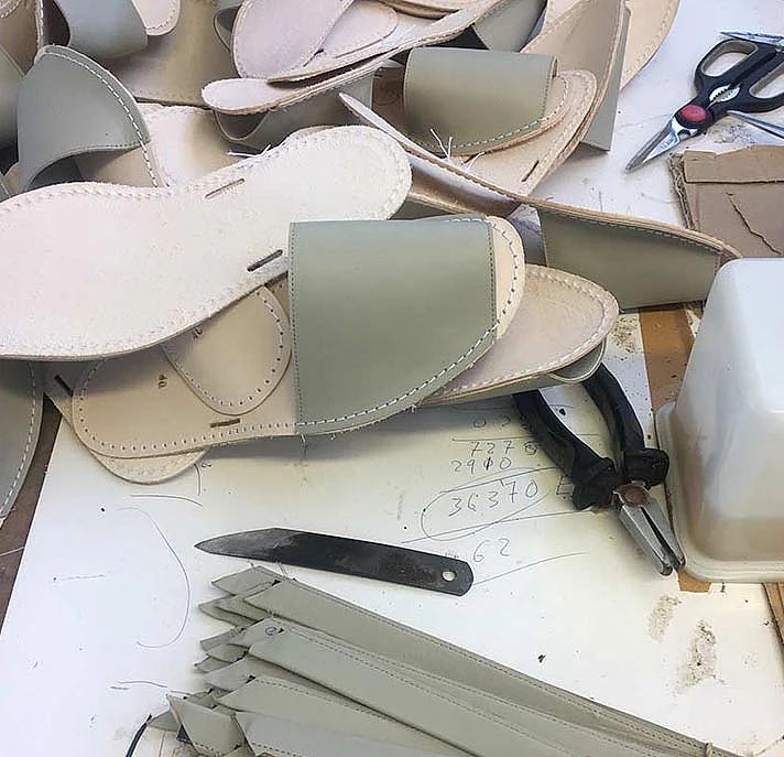 A pile of pieces of leather sitting on top of a table.