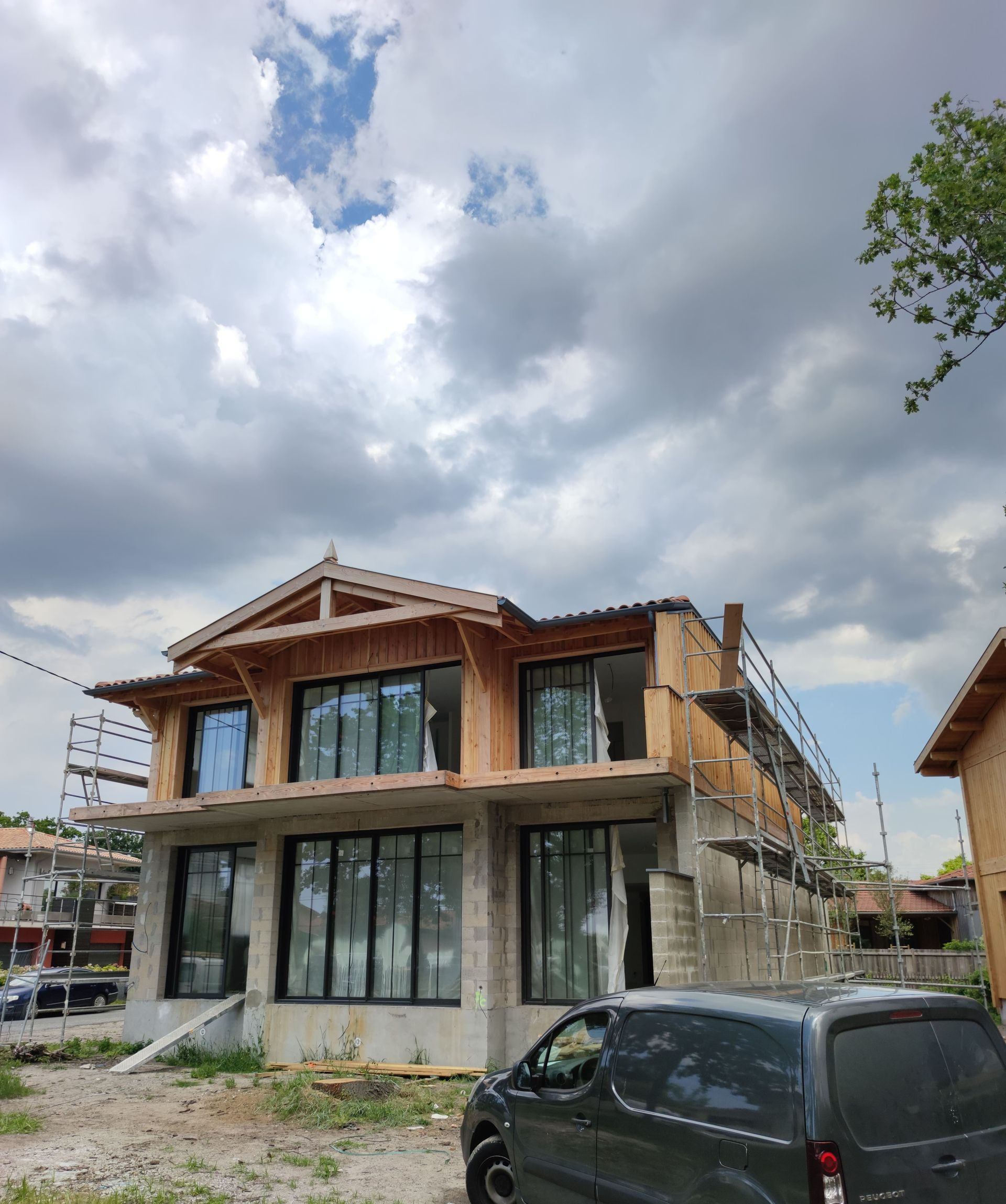 Une maison en construction sur laquelle on applique du bardage