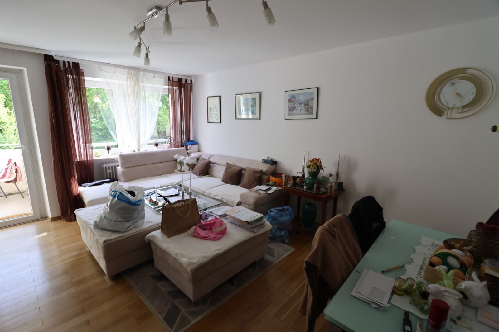 Ein helles Wohnzimmer mit einer Sitzgruppe und einem Esstisch.