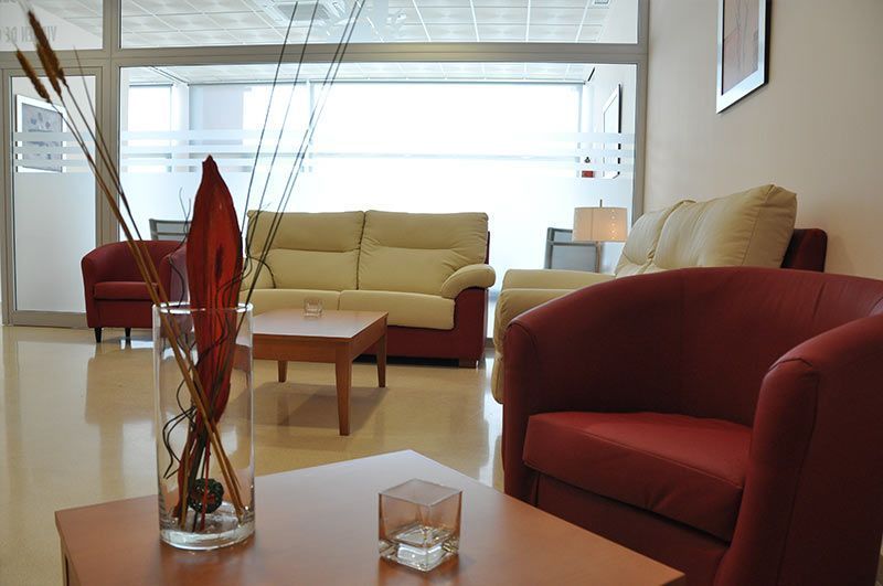 Una sala de estar con un jarrón de flores sobre una mesa.