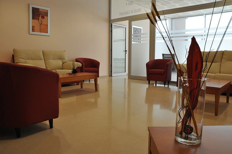 Una sala de estar con un jarrón de flores sobre una mesa.