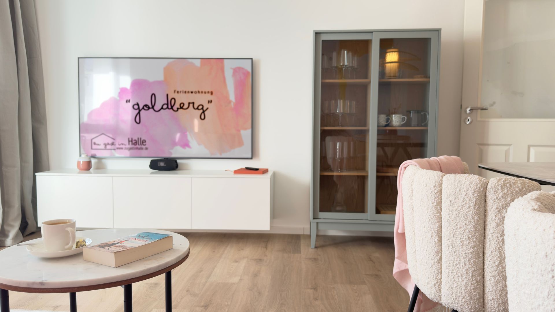 Wohnzimmer der Ferienwohnung Goldberg mit Vitrine, Schrank und TV