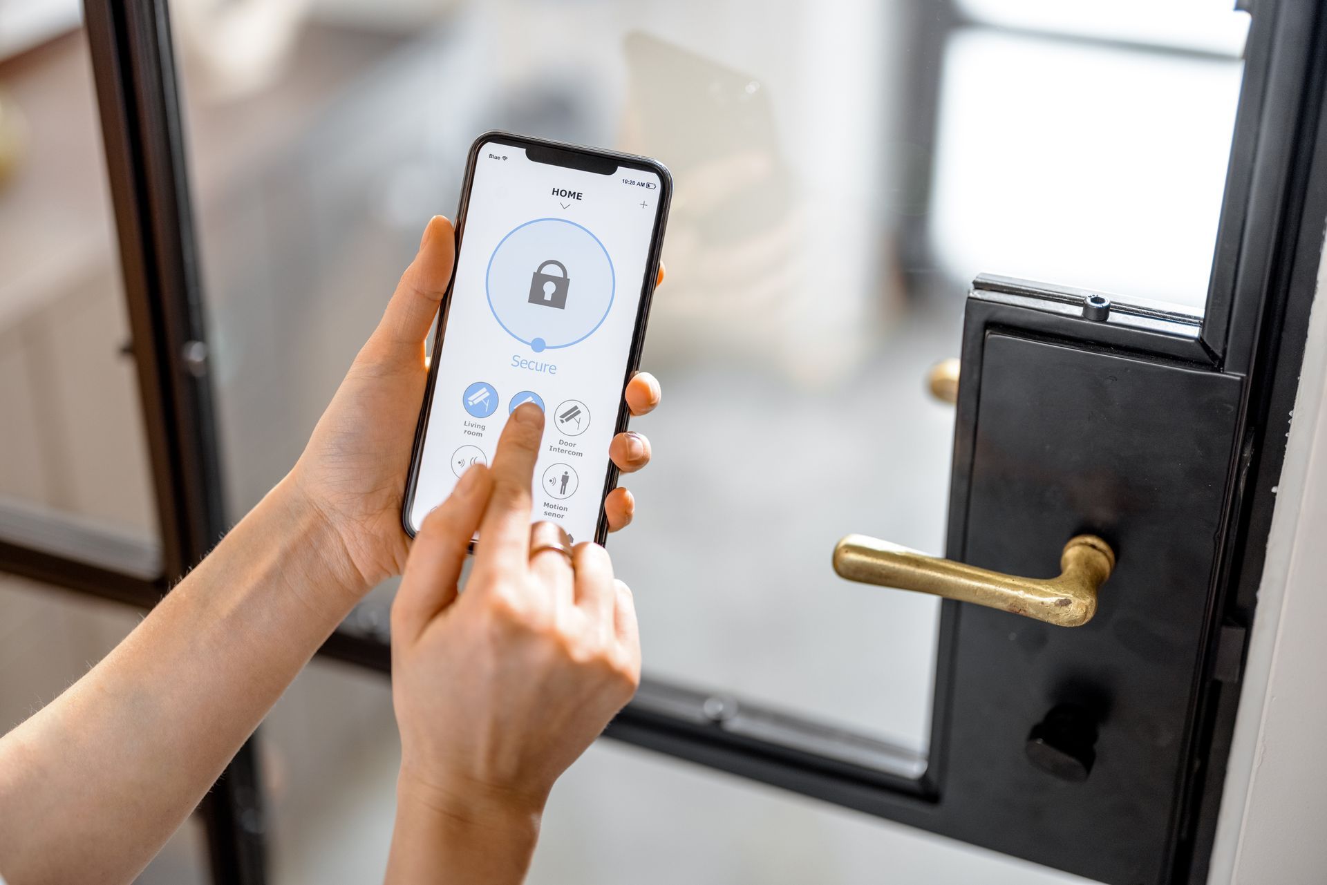 Une personne déverrouille une porte d'entrée avec une application pour smartphone.