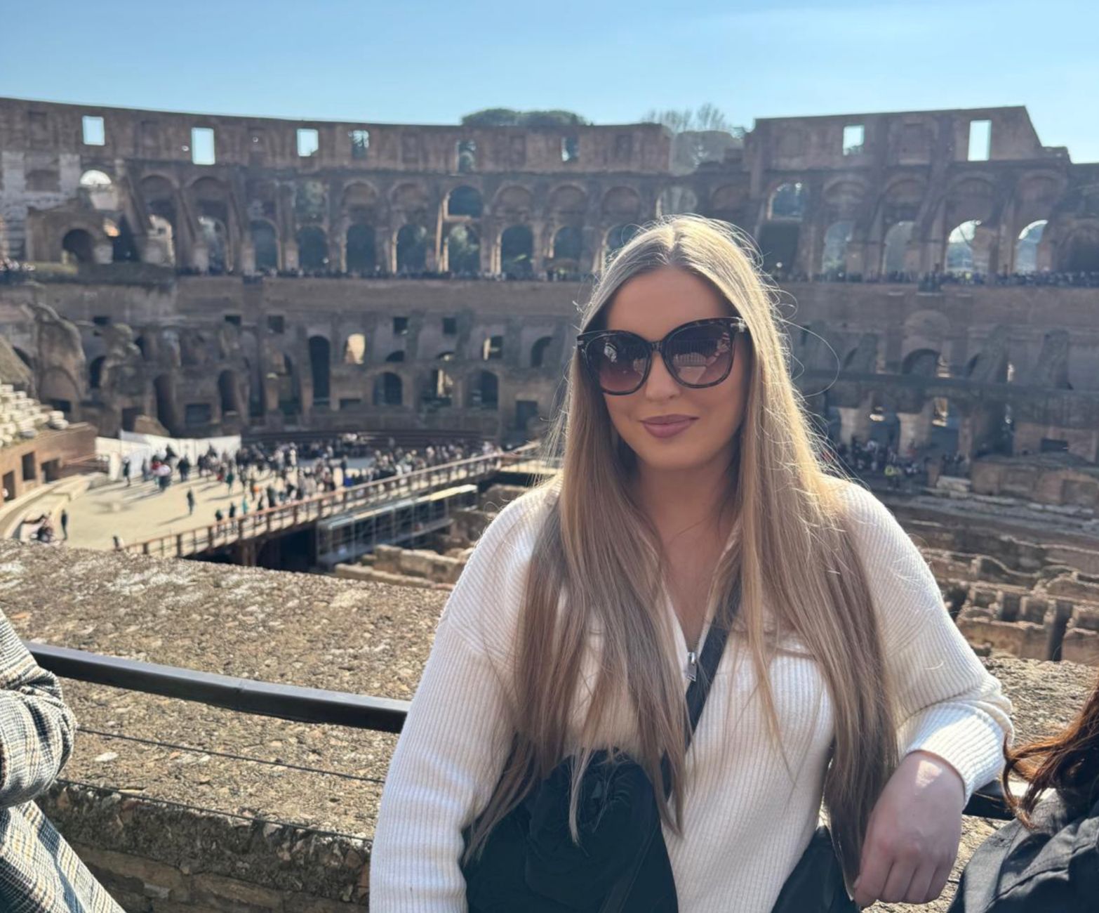 Woman in sunglasses at the Colosseum in Rome.
