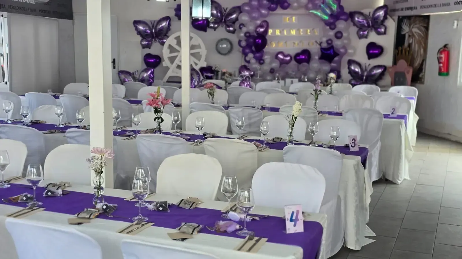 Una gran sala con mesas y sillas preparadas para una fiesta.