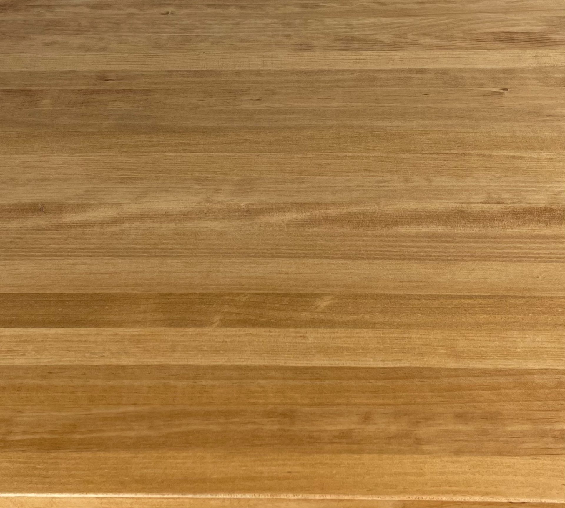 Una mesa de madera con una base negra sobre un fondo blanco