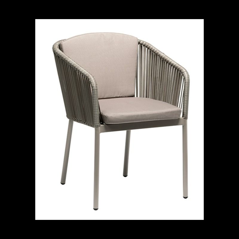 Una silla de mimbre con un cojín blanco sobre un fondo blanco.