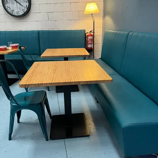 Un restaurante con mesas y sillas y un reloj en la pared.