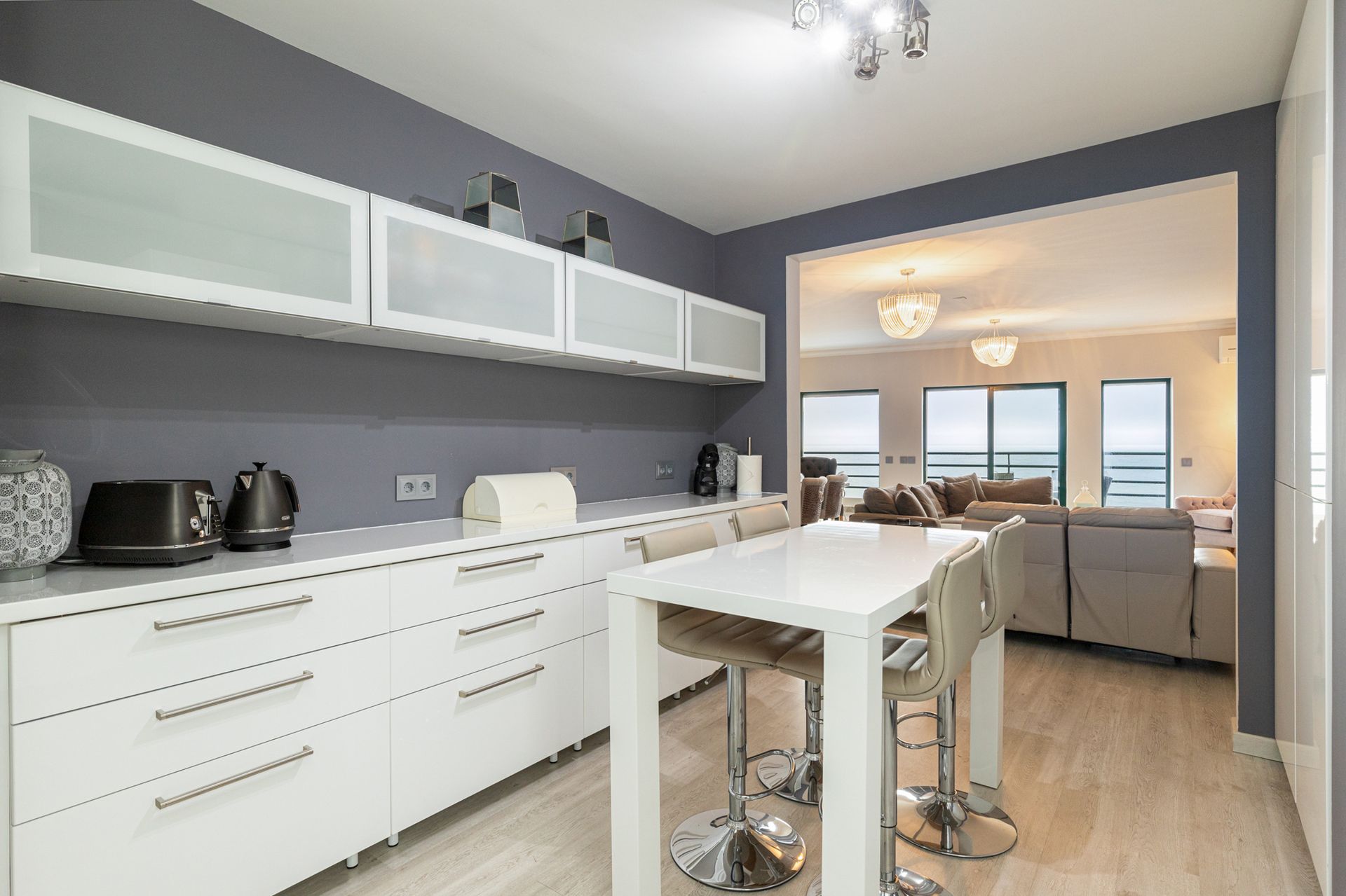 The kitchen and sea-view living area of a managed apartment on the Estoril coast