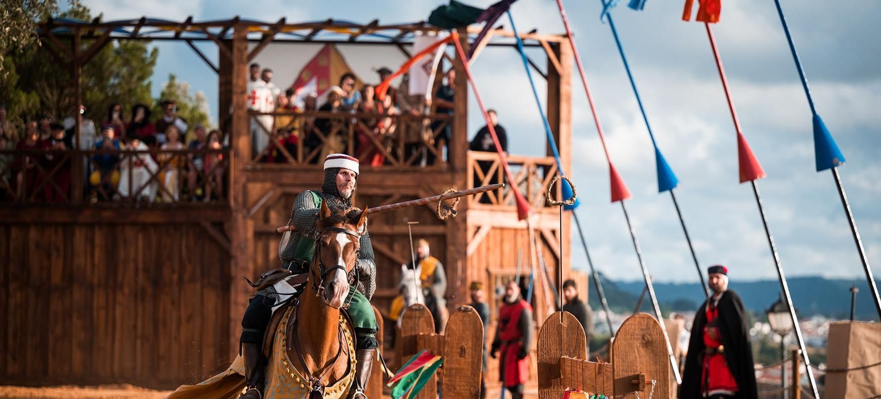 A man is riding a horse in front of a crowd.