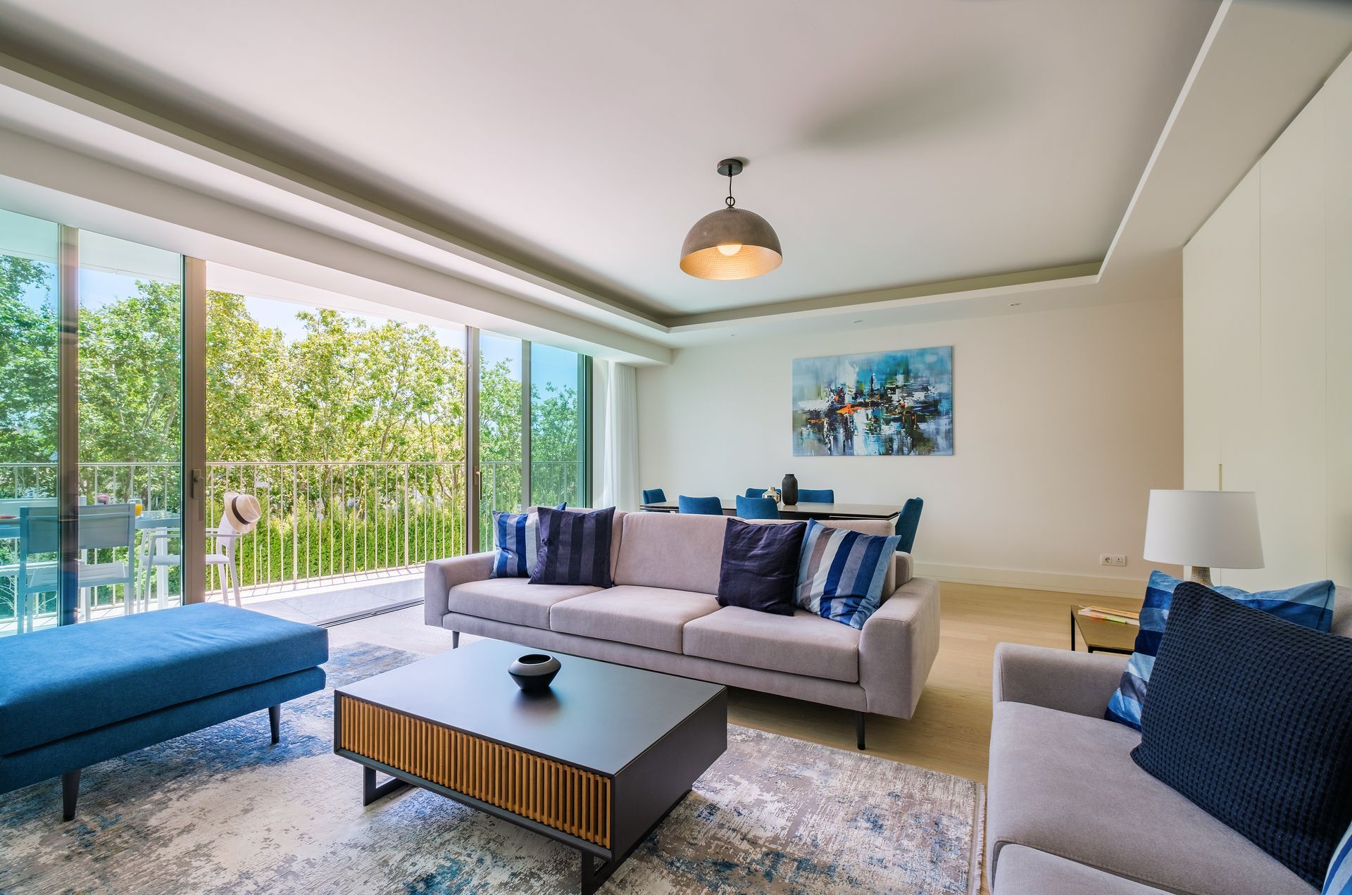 A living room with a couch , chairs and a coffee table.