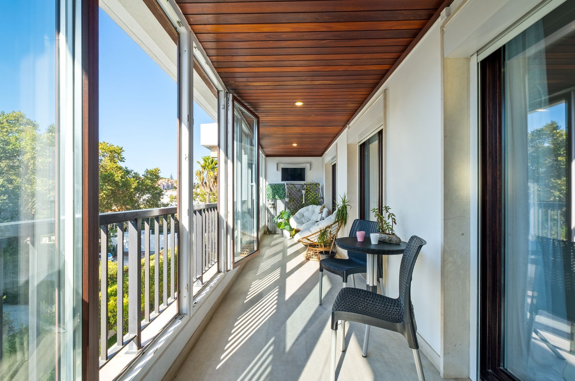 A large balcony with a table and chairs on it