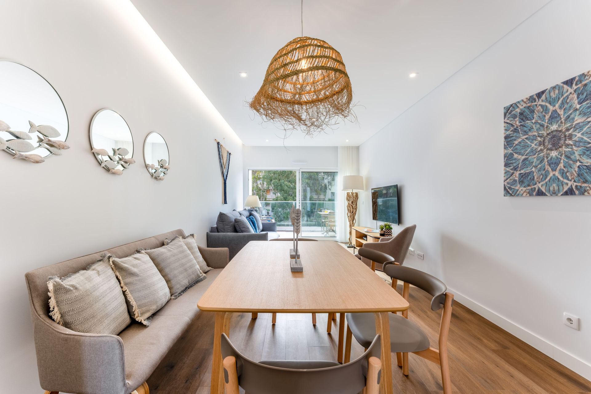 A dining room with a table and chairs and a couch